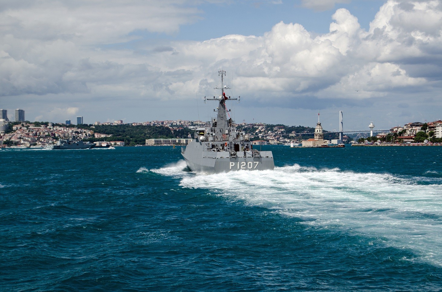 ISTANBUL TURKEY - JUNE 8 2016: The Navy patrol ship Tekirda sailing along the Bosphorus and the landmark Maiden's Tower in Uskudar. The Turkish ship is escorting the larger Russian frigate Admiral Grigorovich which can be seen to the left