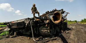 Ukraine: Novodarivka NOVODARIVKA, UKRAINE - JULY 21, 2023 - A press officer who goes by callsign Damian stands on top of a destroyed Russian military vehicle in Novodarivka village, Zaporizhzhia Region, southeastern Ukraine. Situated on the border between Zaporizhzhia and Donetsk Regions, the settlement that had been occupied since March 2022 was liberated by the Ukrainian military on June 4, 2023. Novodarivka Zaporizhzhia Region Ukraine