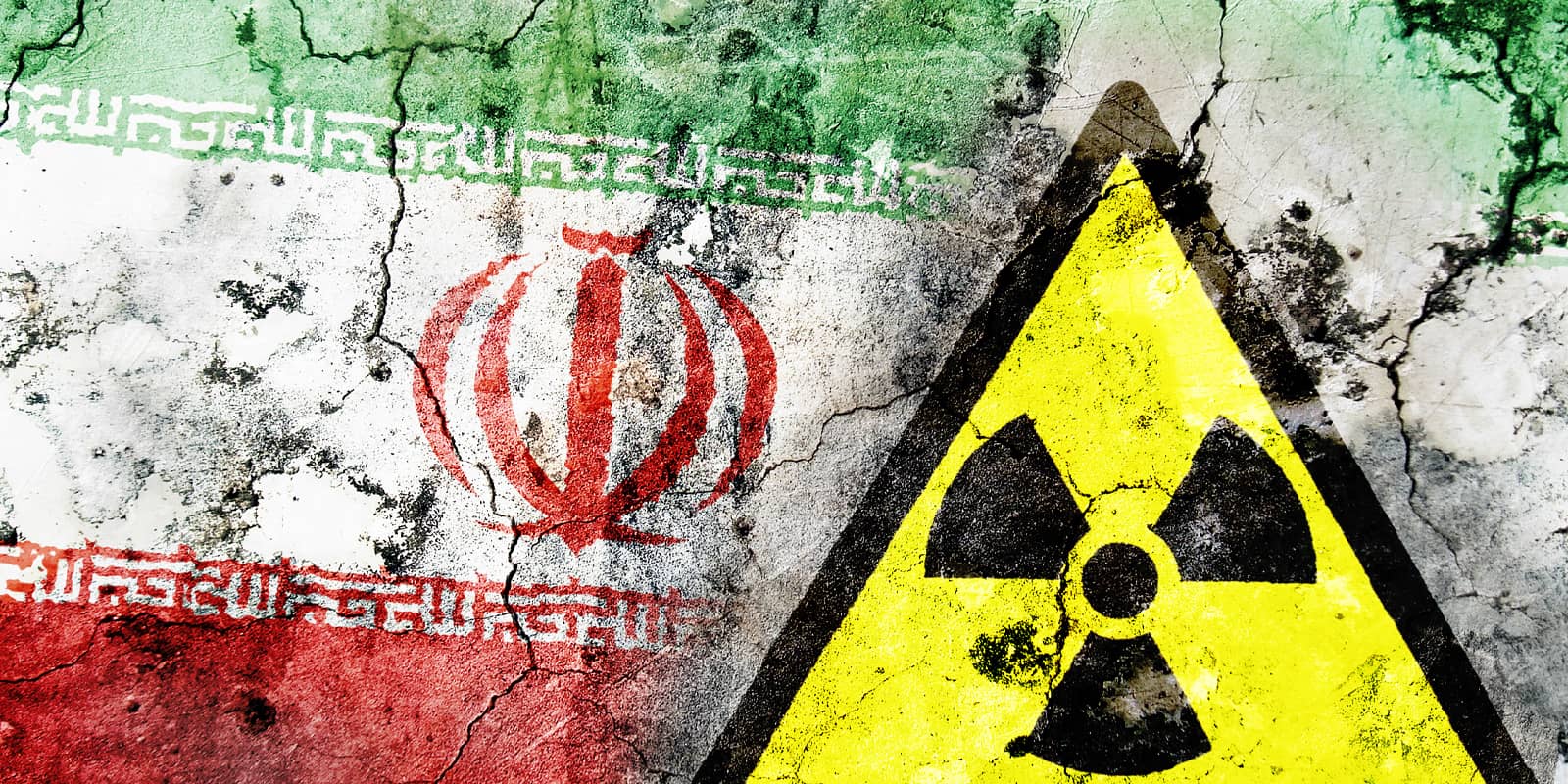 Old cracked wall with radiation warning sign and painted flag, flag of Iran