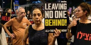 August 15, 2024, Tel Aviv, Israel: A protestor holds a sign that reads Leaving no one behind!