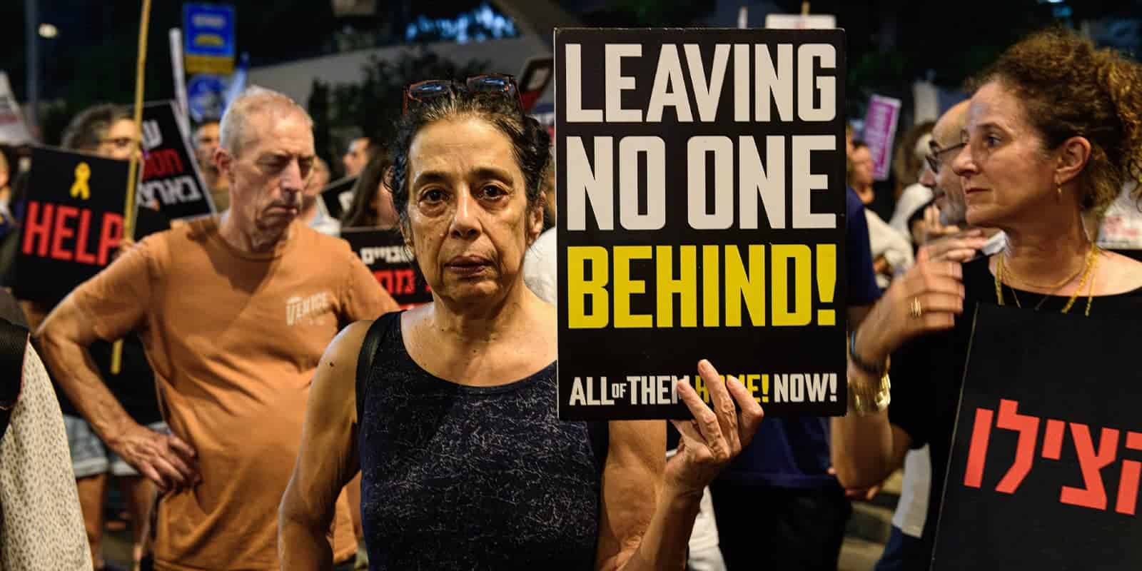 August 15, 2024, Tel Aviv, Israel: A protestor holds a sign that reads Leaving no one behind!